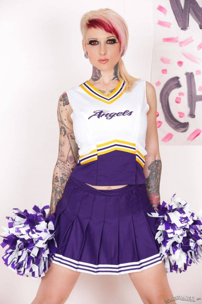 Tattooed chick Scarlet Lavey works free of a cheerleader outfit to pose naked - #4