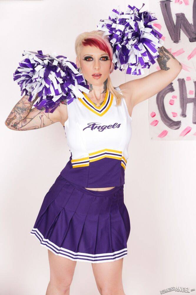 Tattooed chick Scarlet Lavey works free of a cheerleader outfit to pose naked - #14