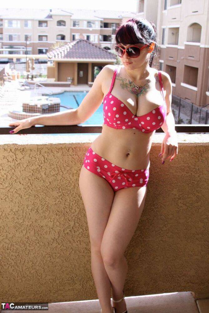Amateur girl Susy Rocks models a polka-dot bikini in shades on a balcony - #11