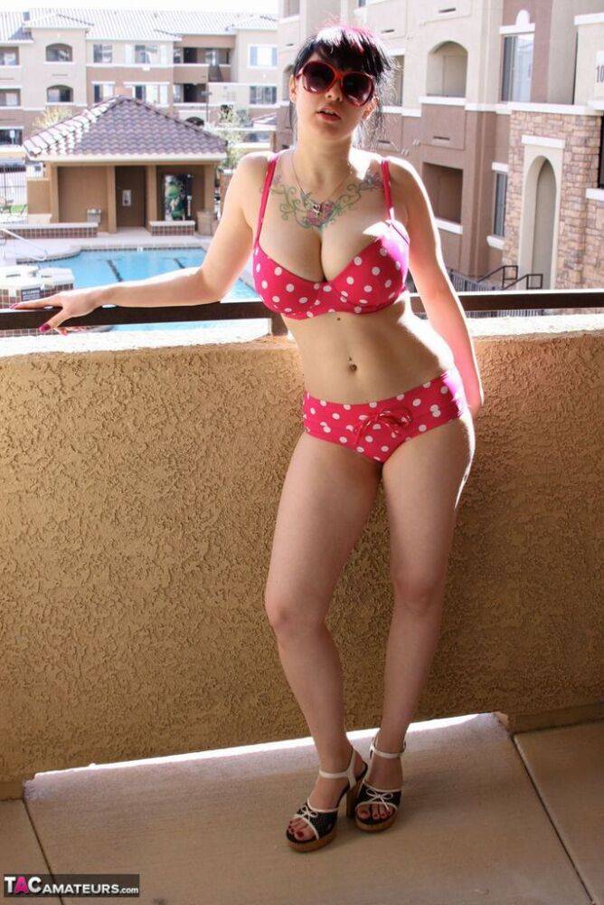 Amateur girl Susy Rocks models a polka-dot bikini in shades on a balcony - #10