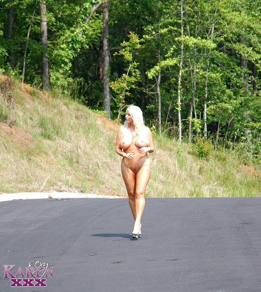 Thick blonde Karen Fisher stands naked in parking lot while modeling naked - #15