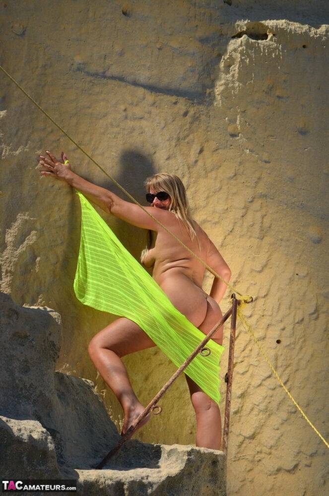 Middle-aged blonde Sweet Susi models naked in a sunny location with shades on - #6