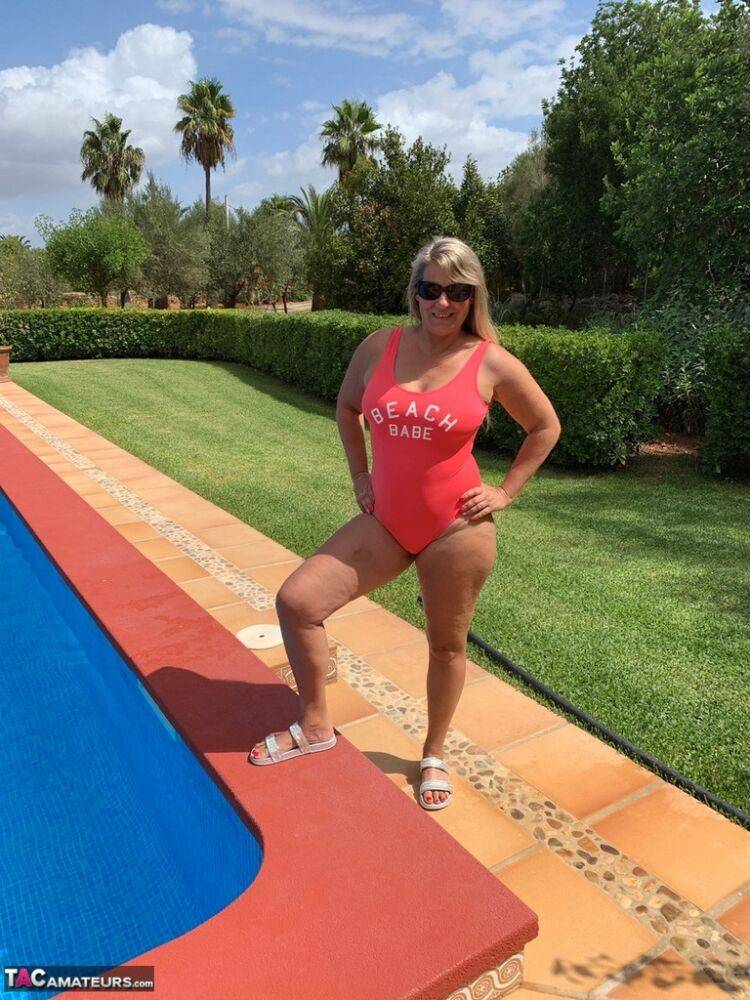 Overweight blonde Sweet Susi frees her tits and twat from a swimsuit by a pool - #1