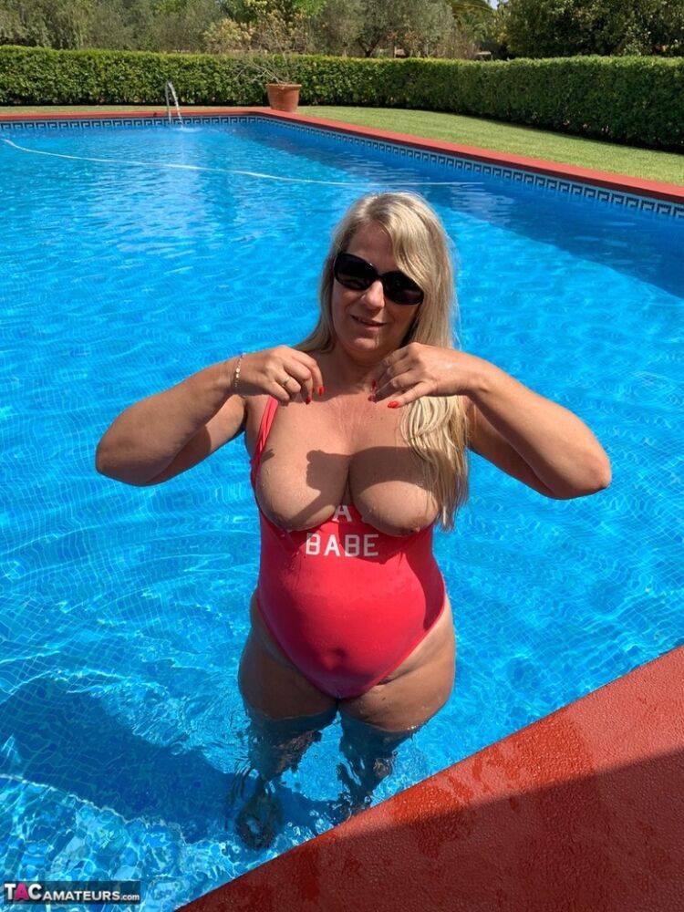 Overweight blonde Sweet Susi frees her tits and twat from a swimsuit by a pool - #5