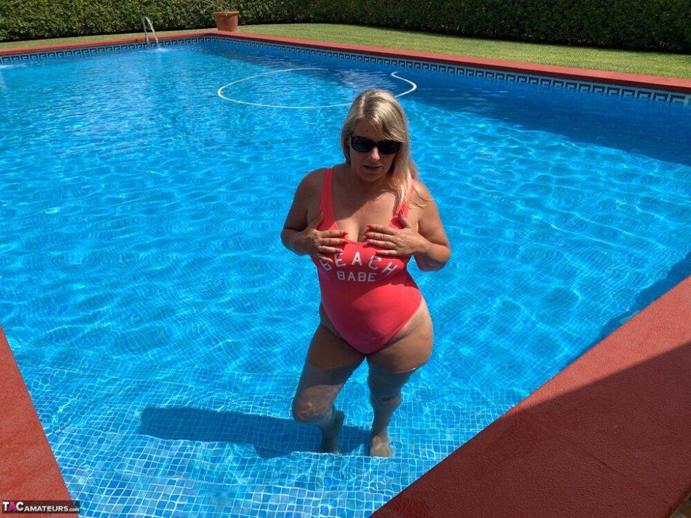 Overweight blonde Sweet Susi frees her tits and twat from a swimsuit by a pool - #16
