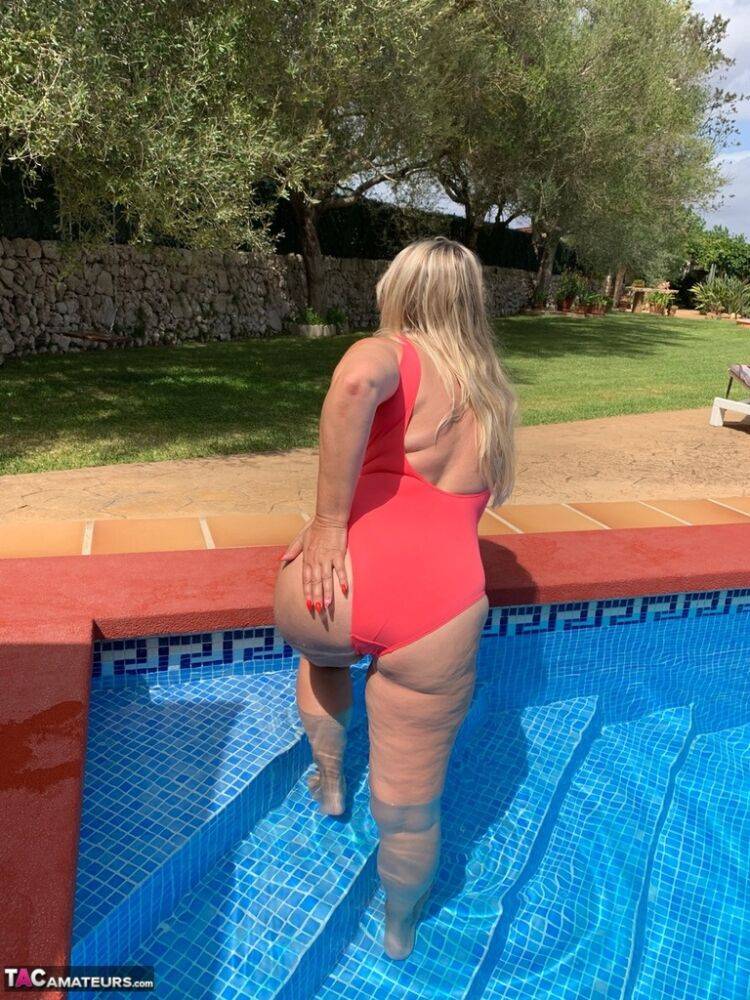 Overweight blonde Sweet Susi frees her tits and twat from a swimsuit by a pool - #13
