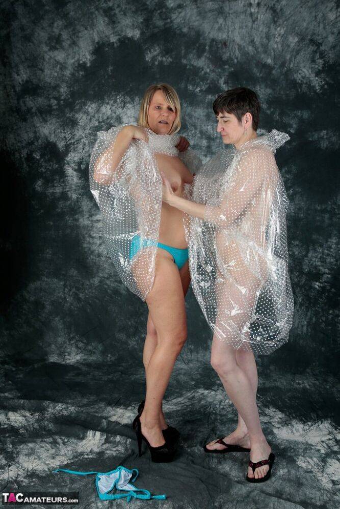 Blonde amateur Sweet Susi and her lesbian lover hump each other in raincoats | Photo: 1330580