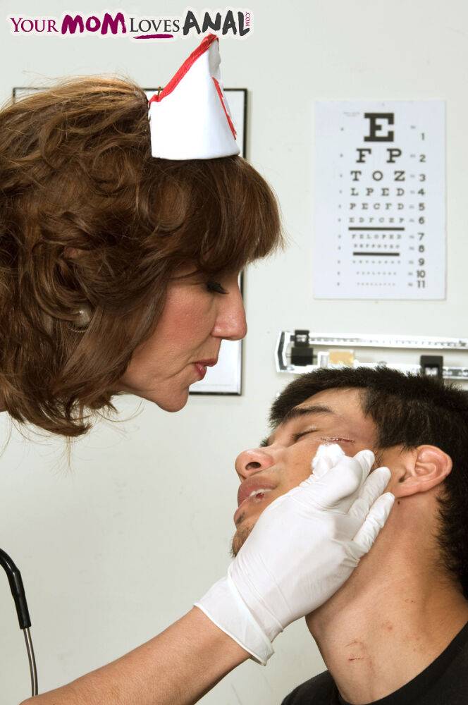 Mature nurse Elle Denay swaps oral with a young boy after cleaning his wounds - #2