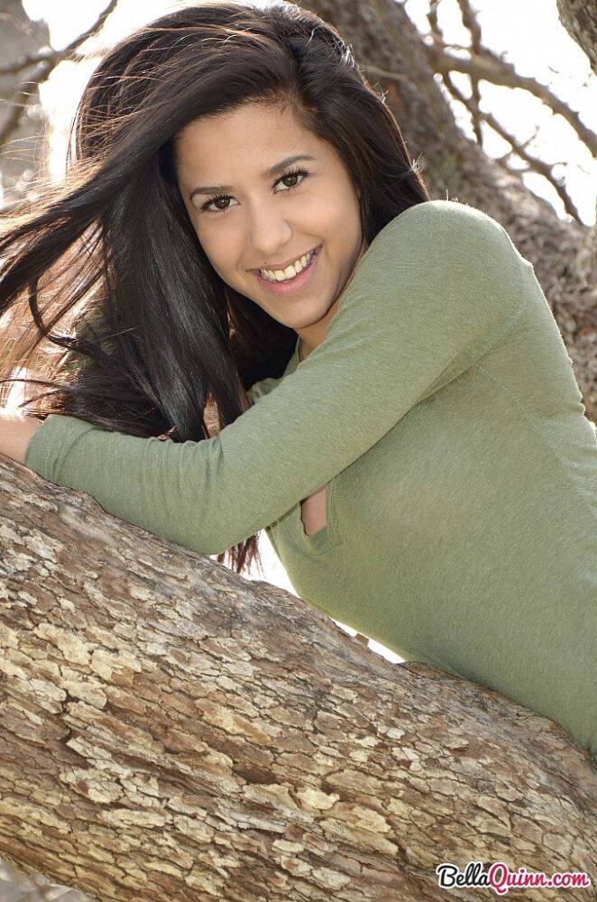 Latina chick Bella Quinn climbs a tree in the park wearing a sweater and jeans - #2