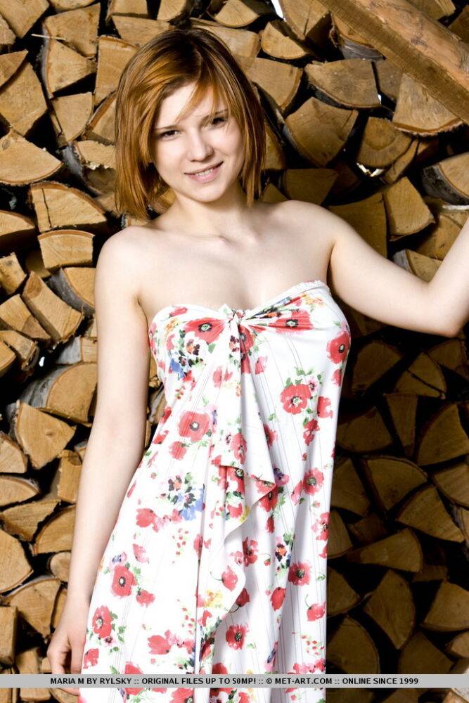 Pale Russian redhead Maria M gets naked in front of split wood at a cabin - #2