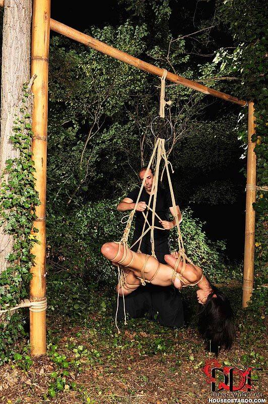 Naked Japanese chick Marica Hase is suspended by rope just outside forest path - #11