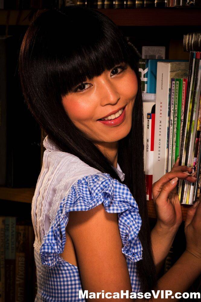 Japanese female Marica Hase flashes her panties while taking a book from stack - #10