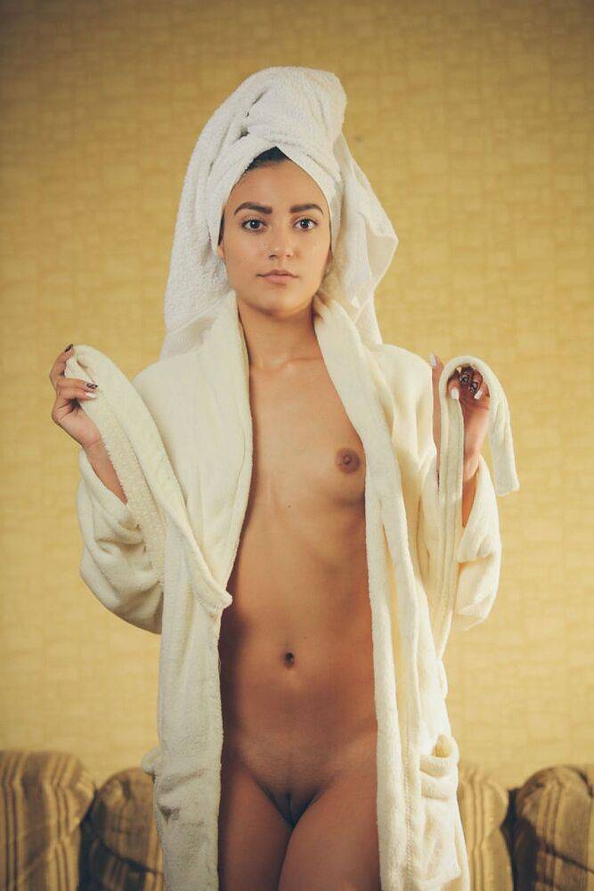 Exotic teen girl Cira Nerri rubs in lotion in a robe and towel - #9