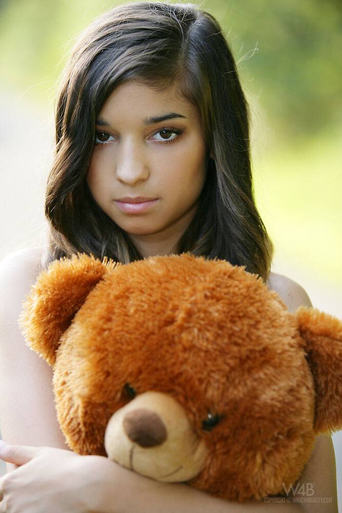 Young looking teen Nika poses naked on a road with a stuffed bear - #14