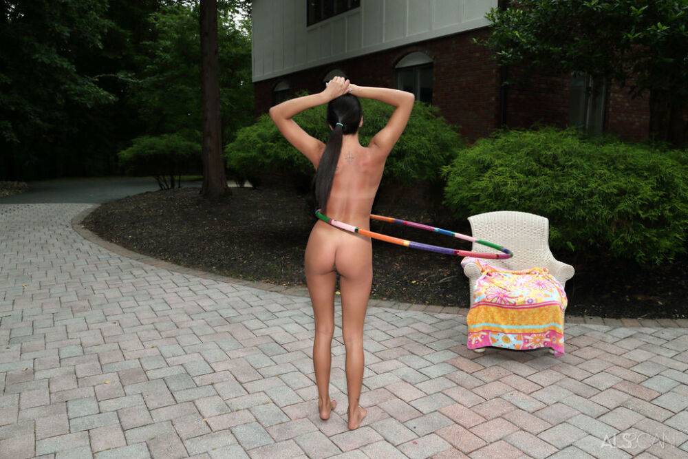 Young amateur Rachel Rivers works a hula hoop while getting naked on a patio - #14