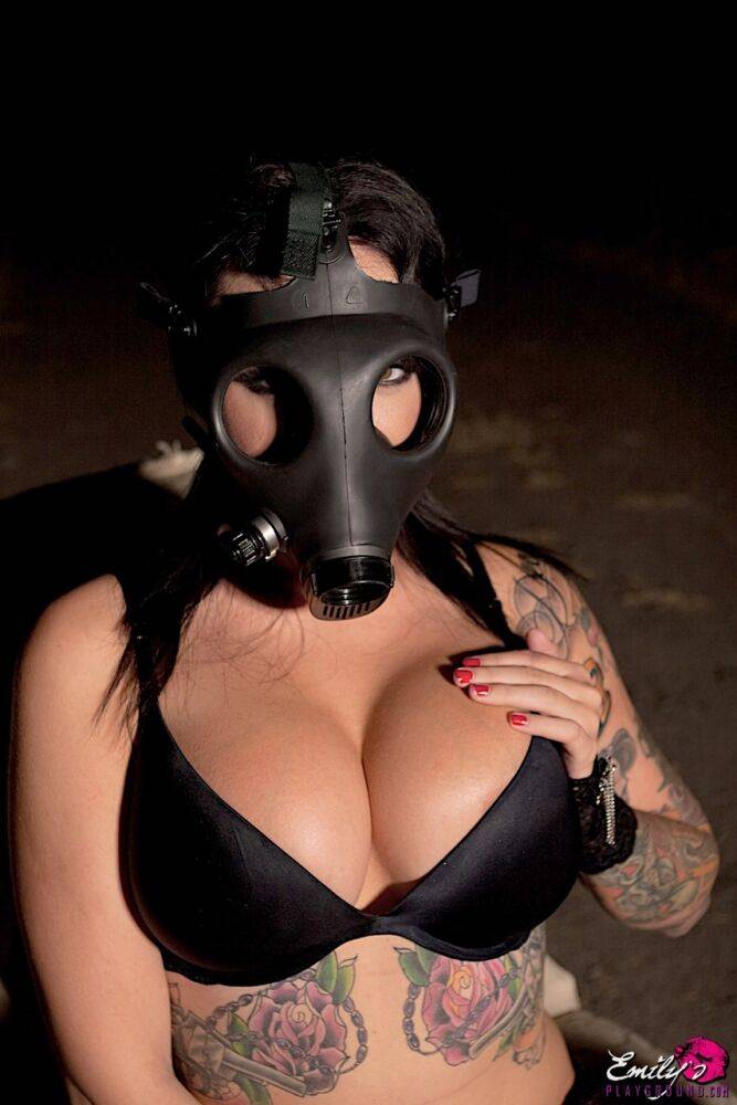 Tattooed girl Emily Parker takes off a gas mask and black bra outside at night - #6