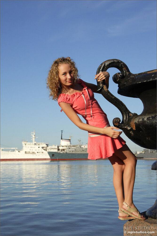 Curly haired girl exposes her pussy and small tits while hanging out on a pier - #1