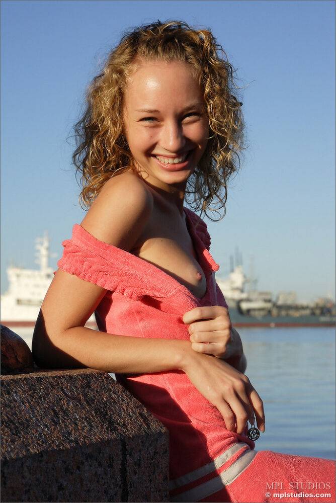 Curly haired girl exposes her pussy and small tits while hanging out on a pier - #6