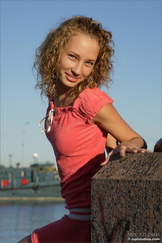 Curly haired girl exposes her pussy and small tits while hanging out on a pier - #8