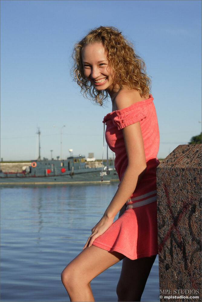 Curly haired girl exposes her pussy and small tits while hanging out on a pier - #12