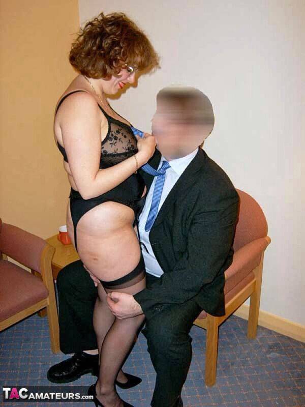 Mature British woman Curvy Claire tit smothers a businessman on a chair - #14