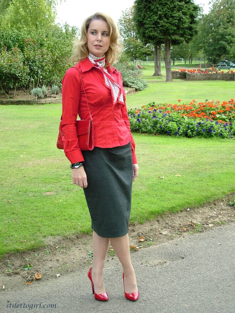 Mature woman crosses her hose covered legs in a long skirt and red pumps - #7