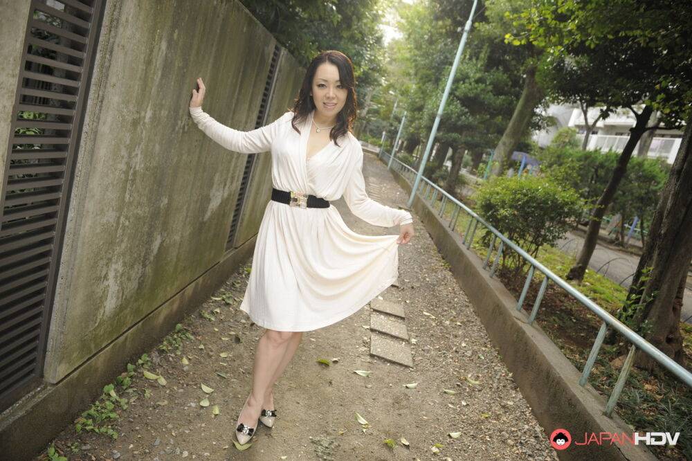 Classy Japanese female Yuna Yamami models non nude outdoors in a white dress - #14