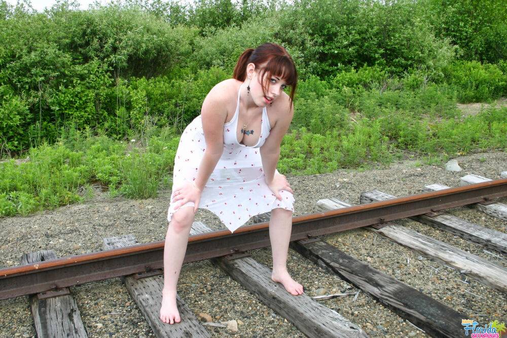 Redheaded girl Barbie A models a summer dress in bare feet on railway tracks - #1