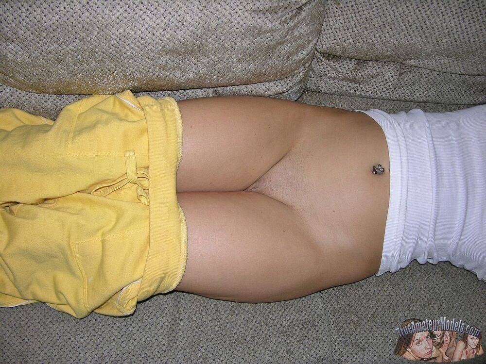 Amateur girl with freckles bares her bum and shaved twat on a living room sofa - #5