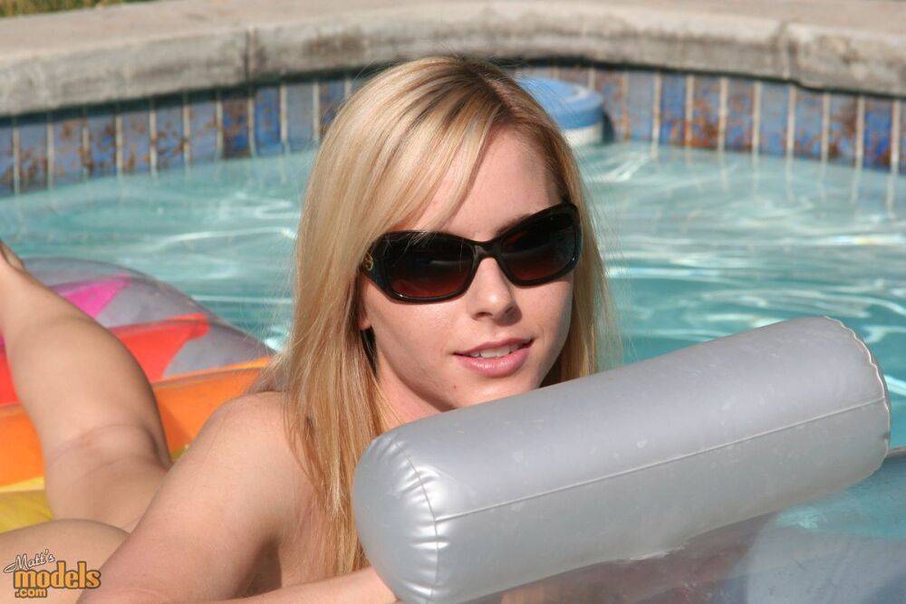 Blonde amateur Kara models naked on an air mattress in sunglasses - #8