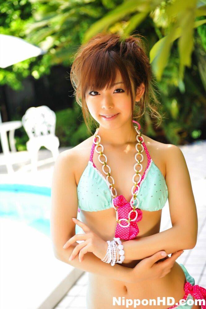 Adorable Japanese girl models a pretty bikini on a poolside patio - #2