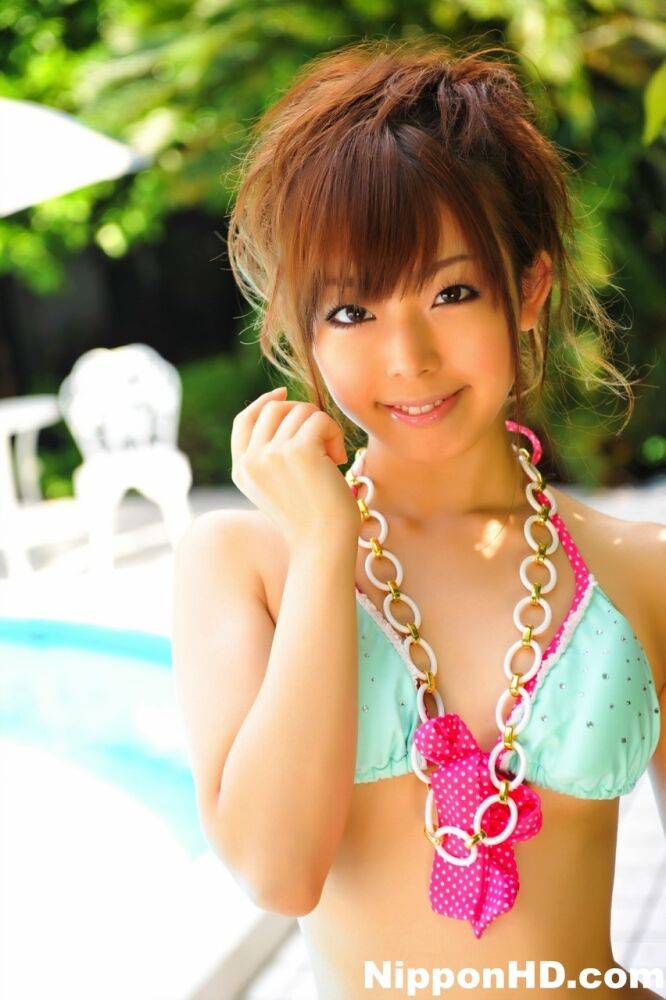 Adorable Japanese girl models a pretty bikini on a poolside patio - #7