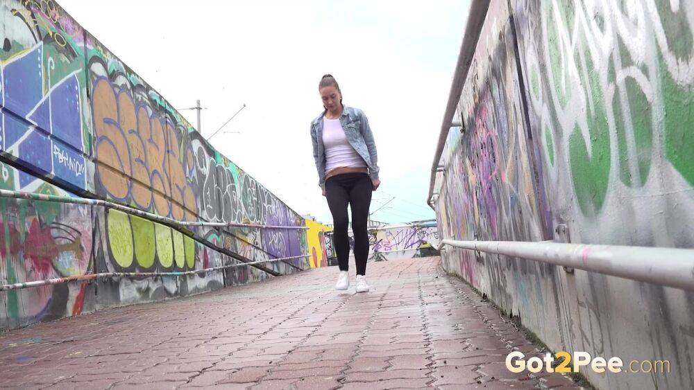 Solo girl Naomi Bennet pulls down black leggings to pee while on a footbridge - #6