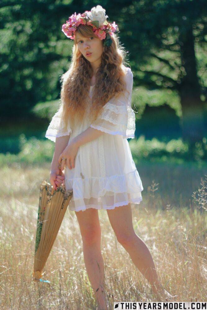 Charming redheaded teen Dolly Little holds a parasol while getting naked - #10