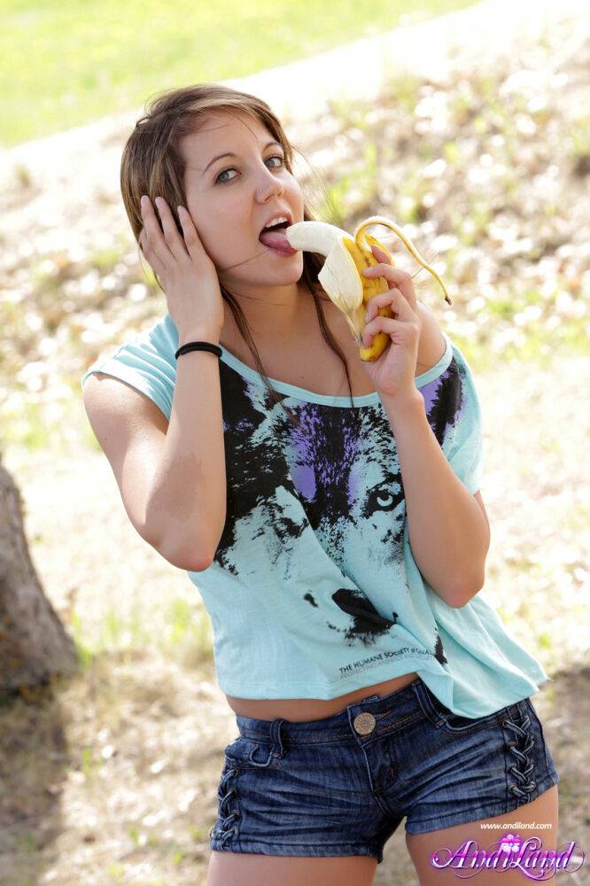 Petite young girl Andi Land exposes herself while eating a banana outdoors - #14