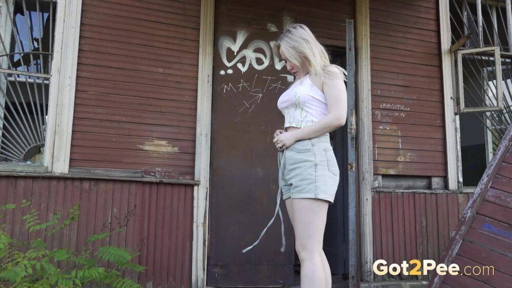 Blonde girl Nastya takes a piss on the steps of an abandoned cabin - #6