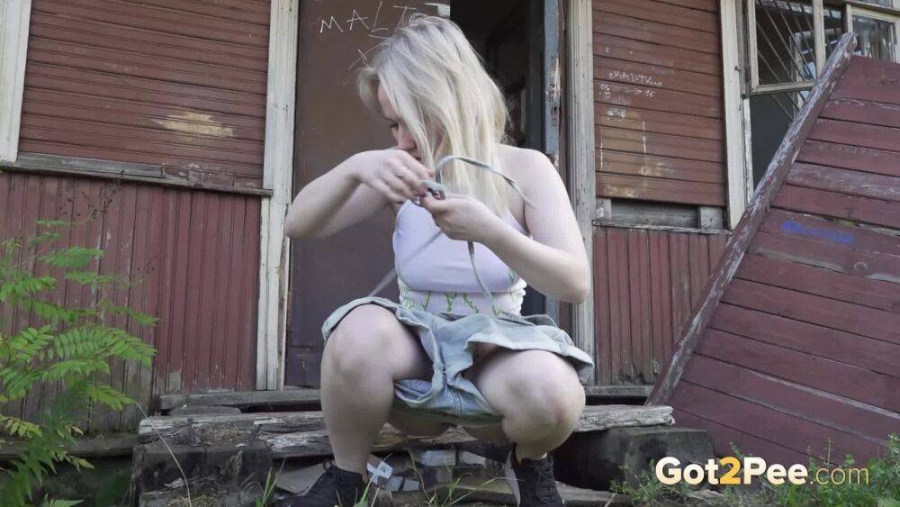 Blonde girl Nastya takes a piss on the steps of an abandoned cabin - #14