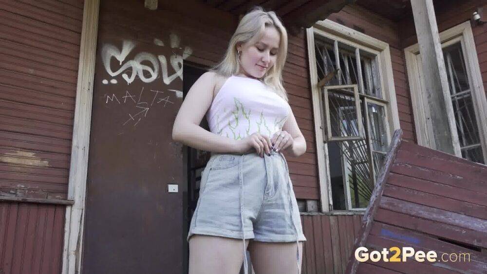 Blonde girl Nastya takes a piss on the steps of an abandoned cabin - #10