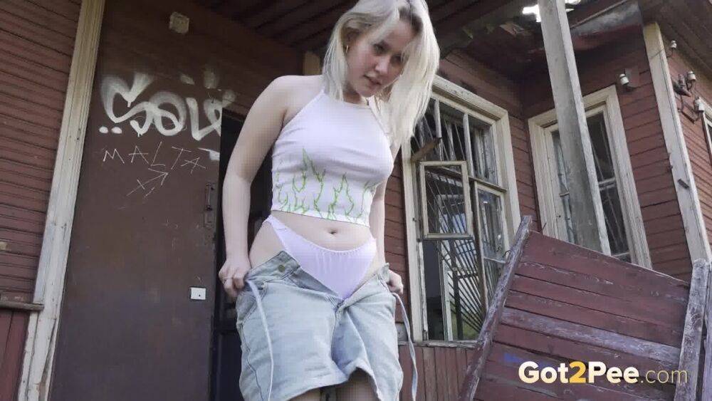 Blonde girl Nastya takes a piss on the steps of an abandoned cabin - #7