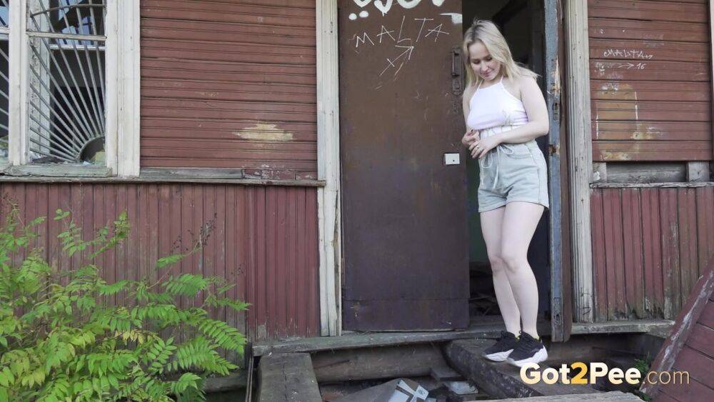 Blonde girl Nastya takes a piss on the steps of an abandoned cabin - #1