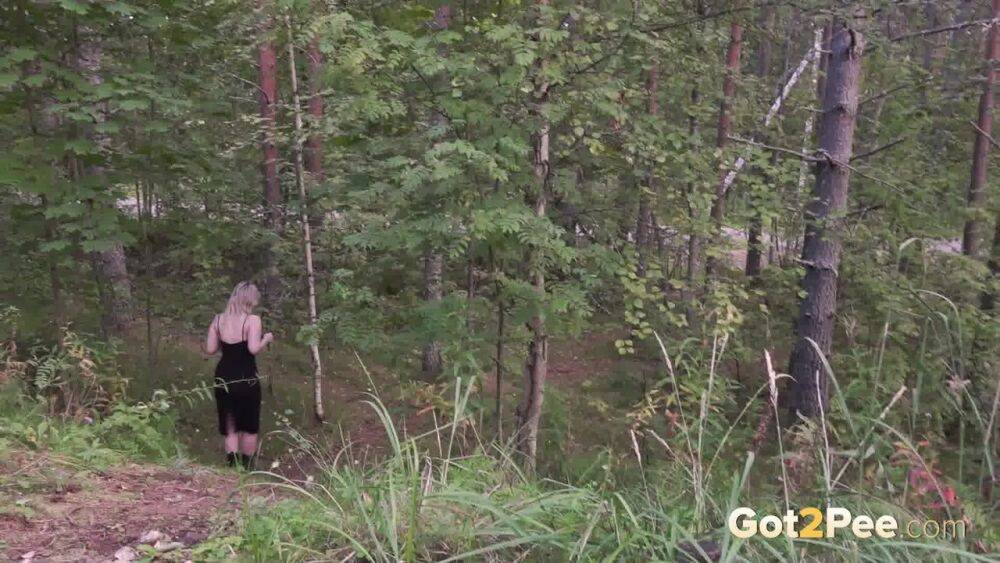 Blonde girl hikes up a black dress to piss in the woods while wearing Docs - #7