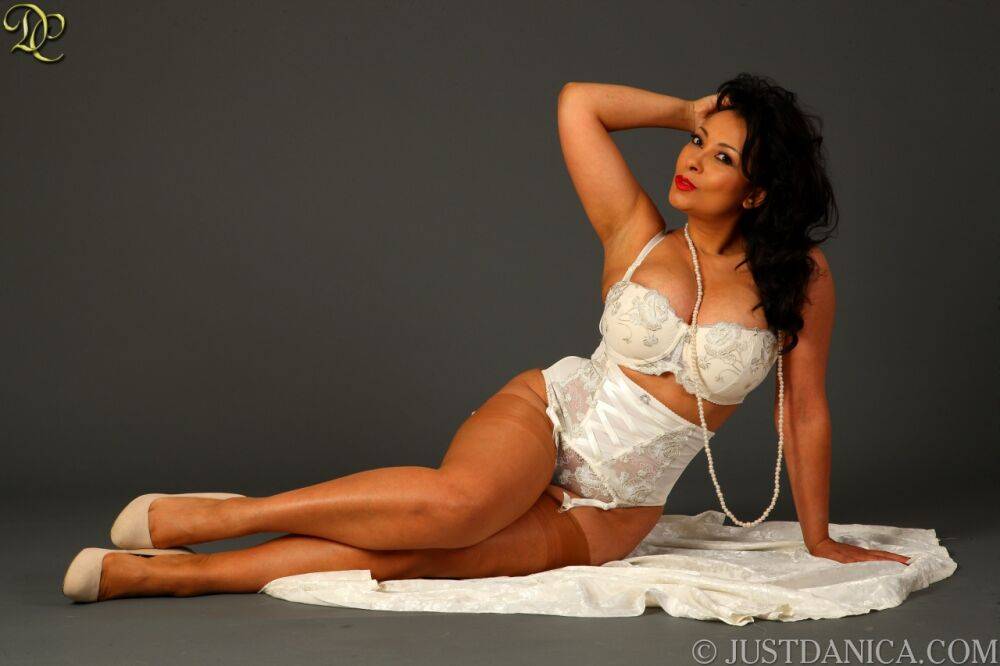 Classy mature woman Danica Collins slips off white lingerie in tan nylons - #11