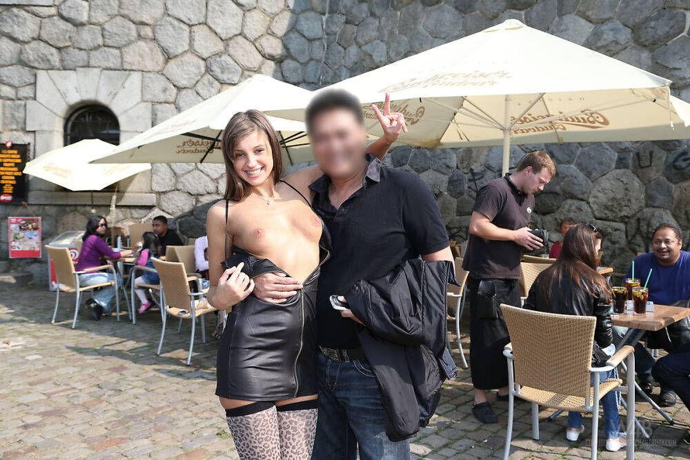 Skinny teen Maria in black leather dress strips naked at a public venue - #9