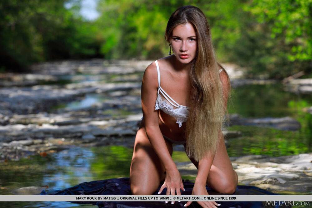 Beautiful young girl Mary Rock gets naked on a rock in a shallow stream - #10
