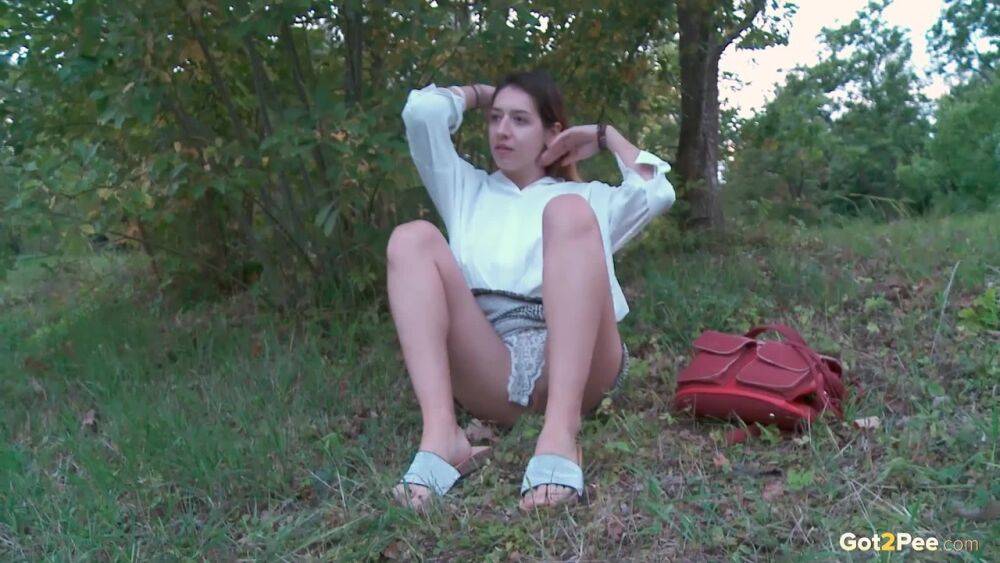 Brunette cutie squats to piss near the lake - #11