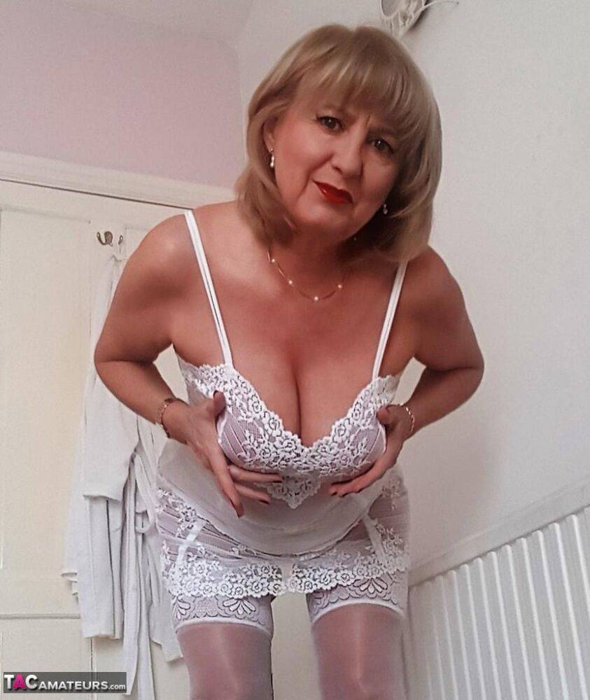 Smiley mature mom Lorna Blu offers her great big tits in white lace lingerie - #10