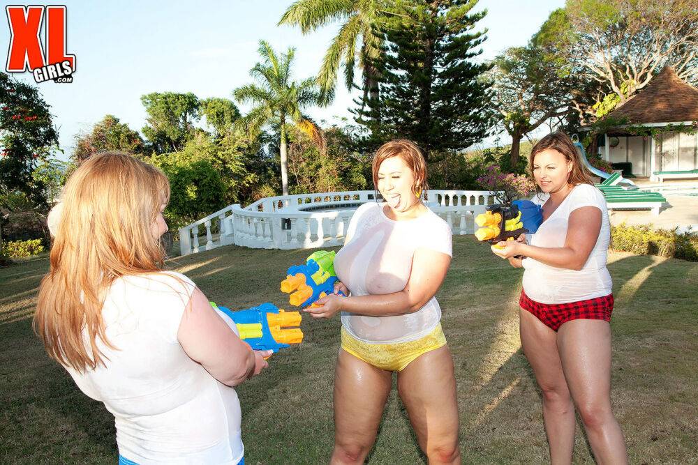 Big titted girls soak white t-shirts in a yard with super-soaker water guns - #3