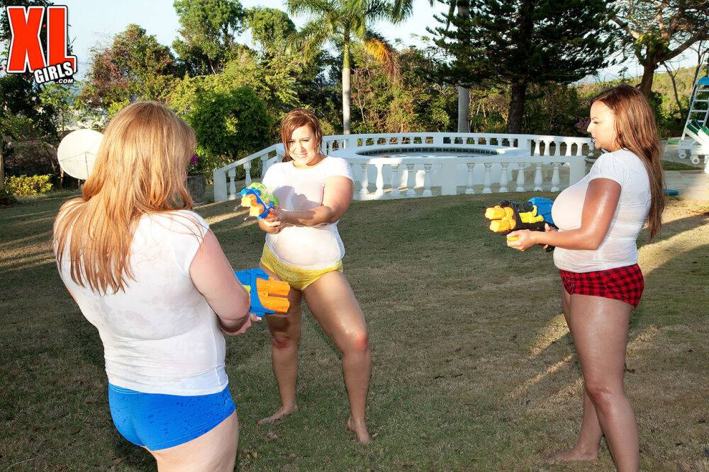 Big titted girls soak white t-shirts in a yard with super-soaker water guns - #9