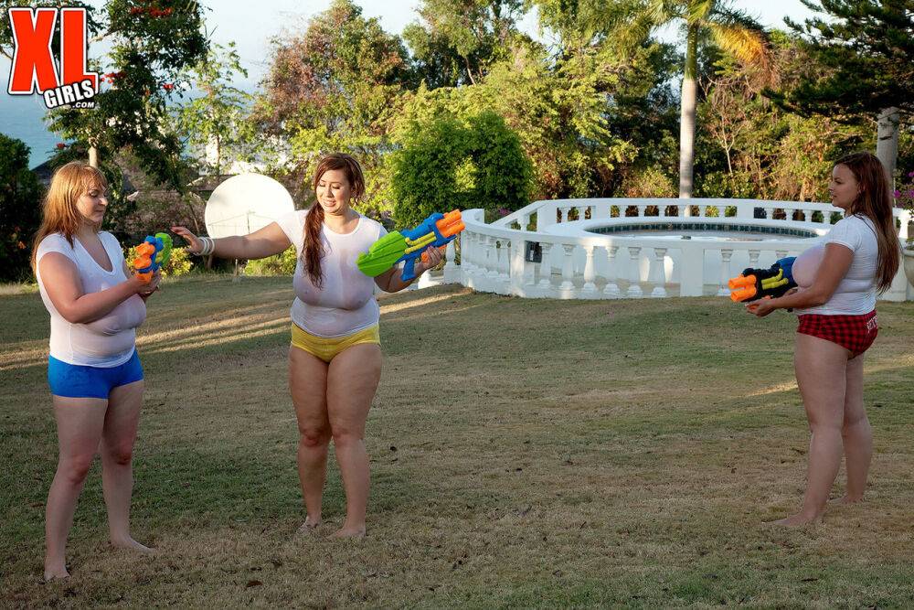 Big titted girls soak white t-shirts in a yard with super-soaker water guns - #15