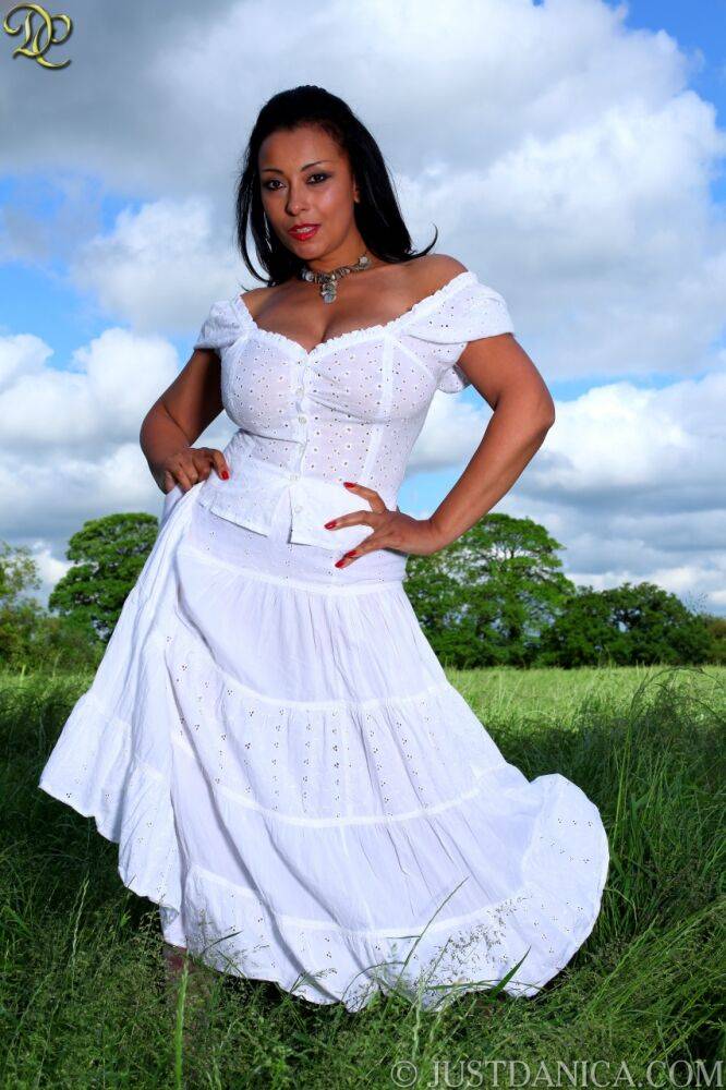 Mature lady Danica Collins looses her large tits from a white dress in a field - #8